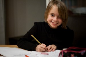 Cheerful child writing